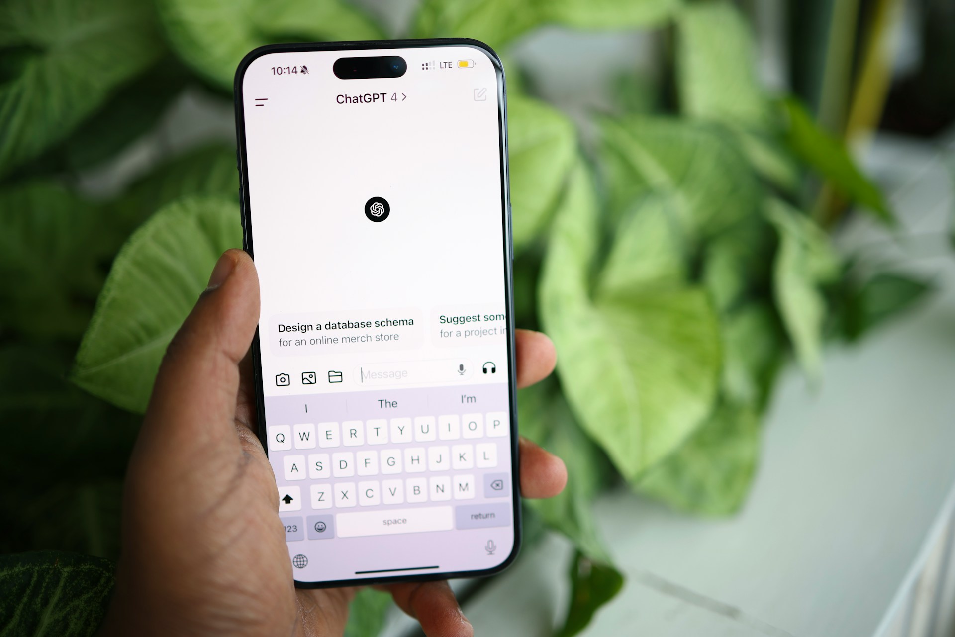 a person holding a cell phone in their hand with the chatgpt app open